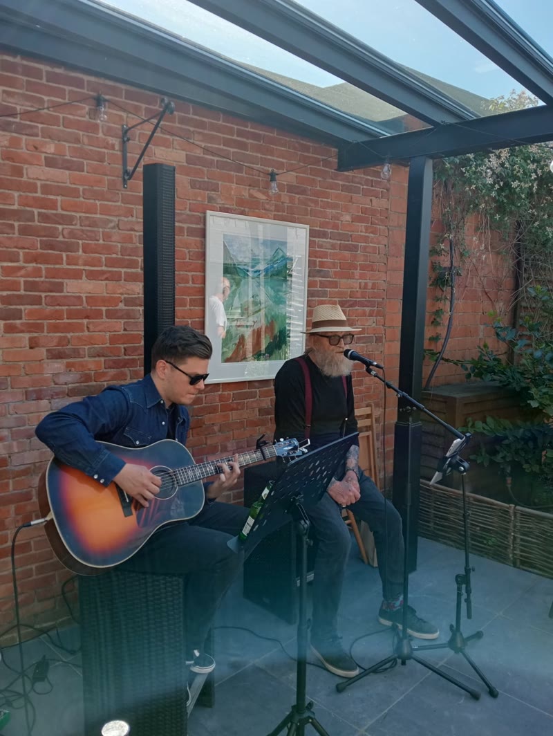 GuitarJoe performing as an acoustic duo with The Voice Senior winner Roland